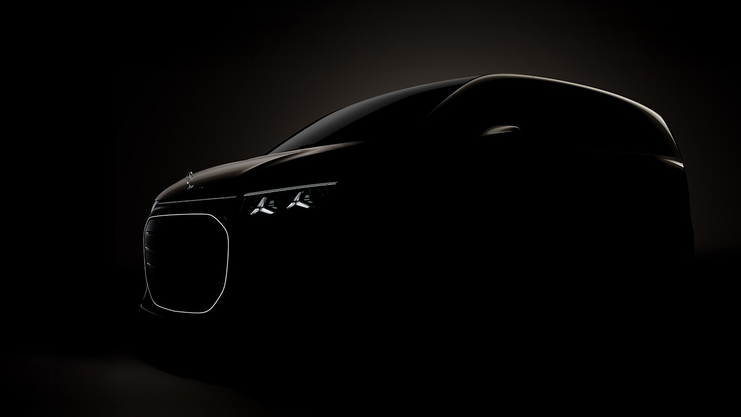 The Mercedes-Benz eSprinter, eCitan and eVito are lined up on display, with the eVito docked at a charging station.