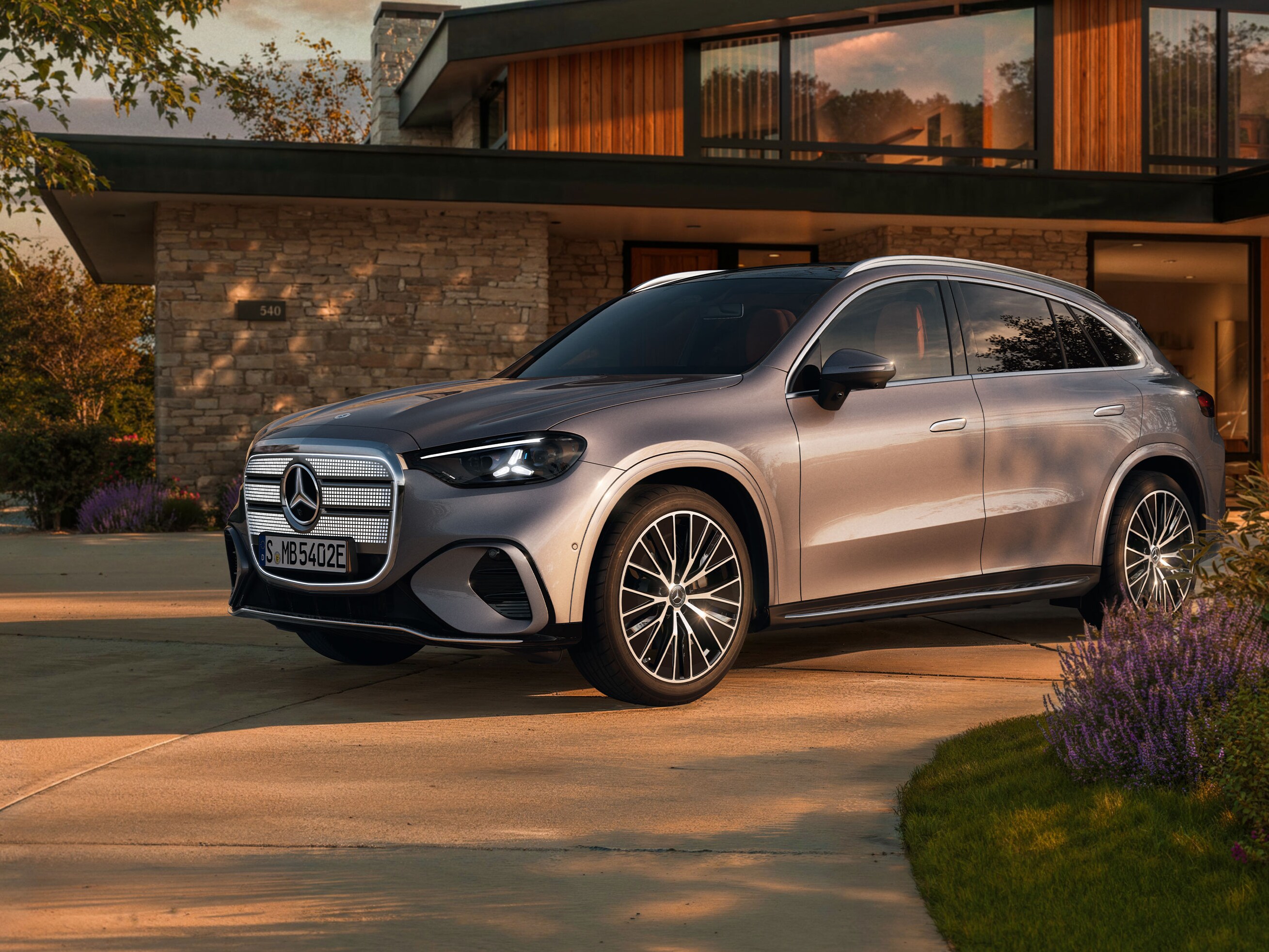 Un homme s'appuie contre un mur à côté d'une Mercedes-Benz.