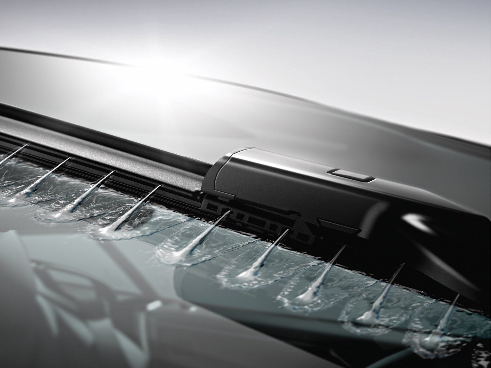 Le liquide d'essuyage est vaporisé sur la vitre