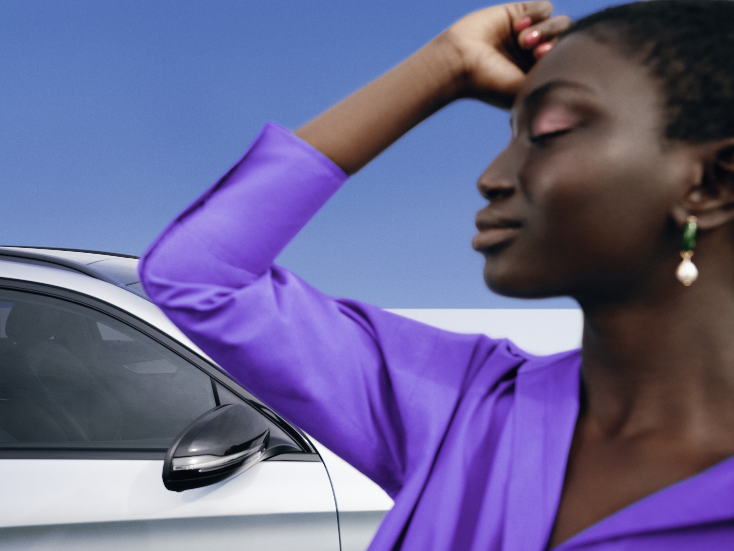 Mercedes-Benz | Produits d’entretien d’origine Le visage fermé, une femme se tient devant sa Mercedes, décontractée.