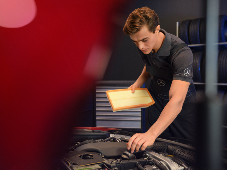 Pièces de rechange Mercedes-Benz Un technicien Mercedes-Benz remplace le filtre à air d'un véhicule.