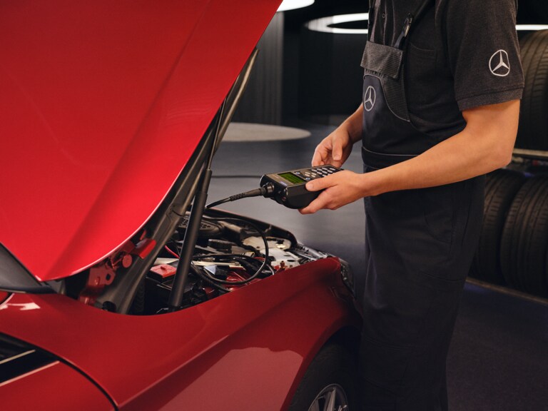 Un technicien Mercedes-Benz vérifie une batterie de voiture.